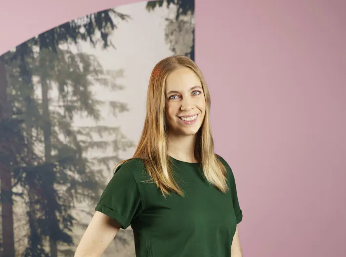 woman in green t-shirt and smiling